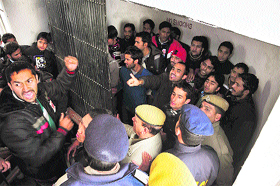 SFI activists raise slogans against the Controller @@of Examination at Himachal Pradesh University in Shimla on Thursday.