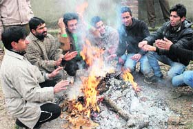 Warming up: Roadside bonfires are a common sight in Srinagar