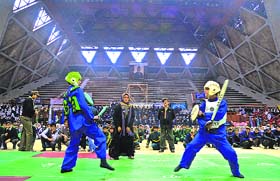 Students play thangta during the annual rally at Indoor Stadium in Srinagar on Thursday