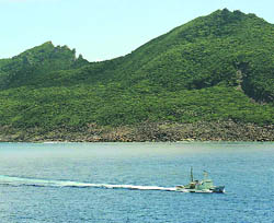 A Japan Coast Guard patrol ship sails around Uotsuri island, part of the disputed islands in the East China Sea, known as the Diaoyu islands in China on Thursday. 
