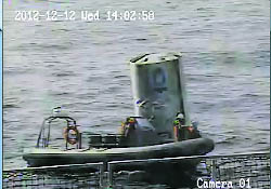 An image released on Thursday by South Korea's defence ministry, shows sailors checking a piece of wreckage of North Korea's Unha-3 (Milky Way 3) rocket, which the defence ministry conjectured to be a fuel container of the rocket, on the sea 160 km off Gunsan, south of Seoul.