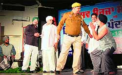 Employees of Punjab State Power Corporation Limited stage a play to spread awareness on saving power to mark National Energy Conservation Day in Amritsar on Friday