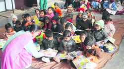 Children spend a cold day on a thin mattress at a creche being managed by the Youth Technical Training Society in Sector 25. 