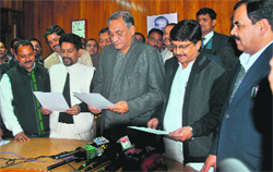 Chief Minister Vijay Bahuguna administers the oath of office to Himesh Kharakwal and Manoj Tewari, both Congress legislators, in the Vidhan Sabha, Dehradun, on Friday. 