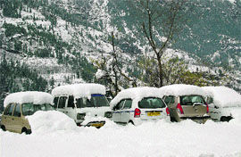 Vehicles covered with snow near Manali. The town experienced a fresh spell of snowfall on Friday.