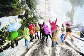 Children enjoy snowfall in Dalhousie on Friday.