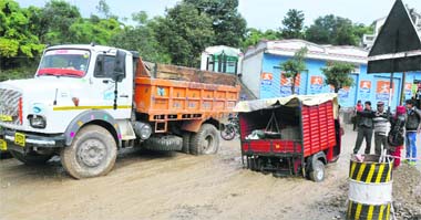 Vehicles are stuck in the mud due to heavy rain at Sidhra in Jammu on Friday. 