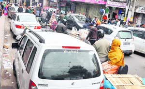 Vehicles parked on the roadside in Jammu. 