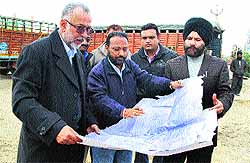 Chief Town Planner Balkar Singh Brar inspects an under-construction building on GT Road in Jalandhar on Friday