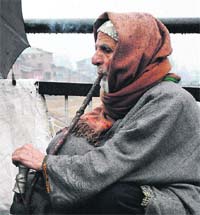 An elderly Kashmiri smokes a hookah in Srinagar on Friday.