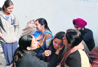 The relatives of Bhavneet Kaur, who committed suicide, break down in Ludhiana on Friday. Photo: Inderjeet Verma