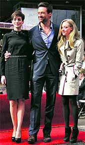 Actress Anne Hathaway (L), Hugh Jackman (C), and Amanda Seyfried pose together during ceremonies honouring Jackman with a star on the Hollywood Walk of Fame in Hollywood, California