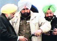 A policeman takes the revolver from advocate Randhir Singh. 