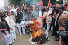 Congress workers burn an effigy of the SAD-BJP government to protest against alleged lawlessness in the state, at the Fire Brigade Chowk in Bathinda on Saturday.