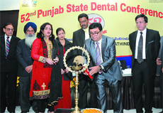 Dr Mahesh Verma lights the ceremonial lamp at the inauguration of the 52nd Punjab State Dental Conference in Bathinda on Saturday.