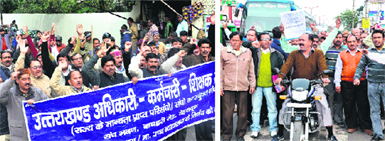 State government employees stage a protest against quota in promotions in Dehradun (left) and Haridwar on Saturday. Tribune photos: Vinod Pundir and Rameshwar Gaur
