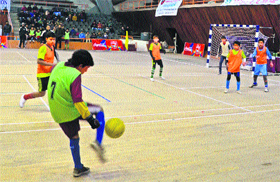 Children in action inside an indoor stadium complex during a match organised by Jammu and Kashmir Football Association in Srinagar on Saturday. For the first time after a gap of 26 years, the stadium opened its doors to a football match. 