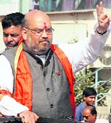 BJP candidate Amit Shah flashes the victory sign during a road show in Naranpura in Ahmedabad on Saturday.
