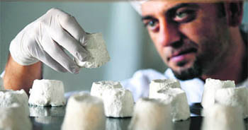 A man inspects donkey cheese in the village of Kukujevci near a farm in Zasavica, Serbia