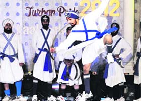 Display of art : Sikh youths perform gatka during the grand finale of Mr Singh International in Amritsar on Sunday