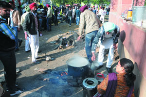 Some of the protesters preparing tea at the site of the dharna. 