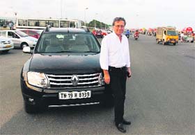 Gerard Detourbet, vice president for Renault's entry-level programme, poses with his Renault Duster in Chennai on Saturday