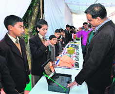 Rajendra Dobhal, Director General, Uttarakhand State Council for Science and Technology, interacts with students during an exhibition at The Indian Academy in Dehradun on Sunday.