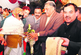 Chief Minister Vijay Bahuguna and Sainik Welfare Minister Harak Singh Rawat honour a relative of a martyr in Dehradun on Sunday.