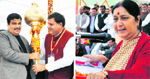 National BJP president Nitin Gadkari is presented a mace at a BJP-HJC rally in Karnal on Sunday; and (right) Sushma Swaraj, Leader of the Opposition in the Lok Sabha, takes on the UPA governtment at the rally.