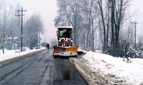 A snow-cutter clears the snow from the Jammu-Srinagar National Highway near Qazigund on Sunday