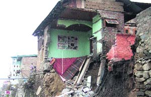 Remnants of a house which got washed away on the banks of the Jhelum in Srinagar on Sunday.