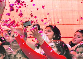 Women shower flower petals on the Rath of Lord Jagannath
