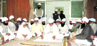 Thakur Uday Singh (on white cloth) during a meeting at Bhaini Saheb on Sunday.