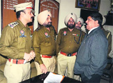Pardeep Kumar Saini meets police officials regarding the case in Amritsar on Monday. 