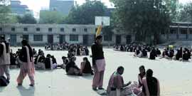 Girl students of senior secondary classes attend their classes sitting on floor in a government school at Kotkapura on Monday.