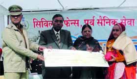 Dignitaries present a cheque to a war widow during a function held at Sriganganagar.