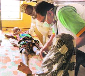 An Indian doctor operates upon a polio-inflicted child at Kubwa in Nigeria