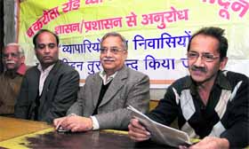 Chakrata road shopkeepers talk to mediapersons in Dehradun on Monday.