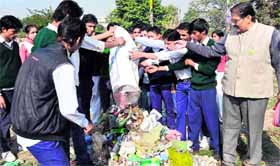 Students clean ghats as part of the Sparsh Ganga Abhiyan in Haridwar on Monday.