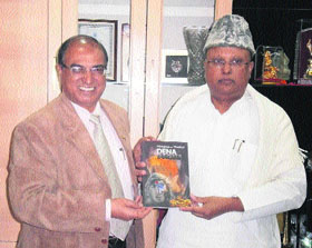 Swami (Dr) Parthasarathy (right) along with Prof (Dr) MM Goel, an economics professor at KU, releases the drama book Dena-Paona (Debit-Credit).