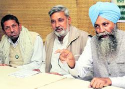 Haryana BKU chief Gurnam Singh (right) makes a point during a press conference in Chandigarh on Monday. 