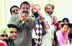 Members of the Dynamic Congress Group Sharwan Grover, Harsimranjit Banti, Sushil Rinku and Bal Krishan Bali show an aggressive posture during the MC House meeting in Jalandhar on Monday.