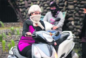 Beat the chill: A girl covers her face to protect from the winter chill in Jammu