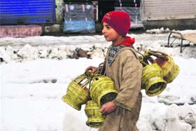 Kangris are here: A boy sells traditional firepots, locally known as kangris, in Qazigund on Monday