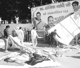 Hoardings of Congress chief Sonia Gandhi were vandalised by anti-quota UP government staff in Lucknow on Monday.