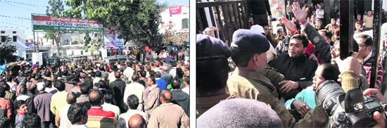 State government employees stage a protest against reservations in promotions in front of Congress Bhawan in Dehradun on Tuesday; and (right) policemen prevent a clash between Congress workers and the protesters