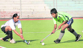 A match in progress between Government Model School, Jalandhar, and St Ignatius School, Gumla, during the ninth All-India Balwant Singh Kapur Hockey Tournament in Jalandhar on Tuesday.