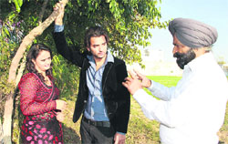 Actors of upcoming film on AIDS Manzil ton agge Amarinder Singh and Esha Singh with director Satwant Singh in Jalandhar on Tuesday.