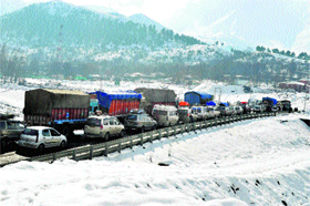 A traffic jam at the Jammu-Srinagar National Highway near Qazigund on Monday. The highway that was closed for traffic last week after heavy snowfall has been reopened for one-way traffic.