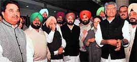 Chief Minister Parkash Singh Badal at the Punjab Vidhan Sabha in Chandigarh; and (right) PCC president Capt Amarinder Singh (centre) along with party legislators hold a protest at the press gallery of the Vidhan Sabha on Tuesday